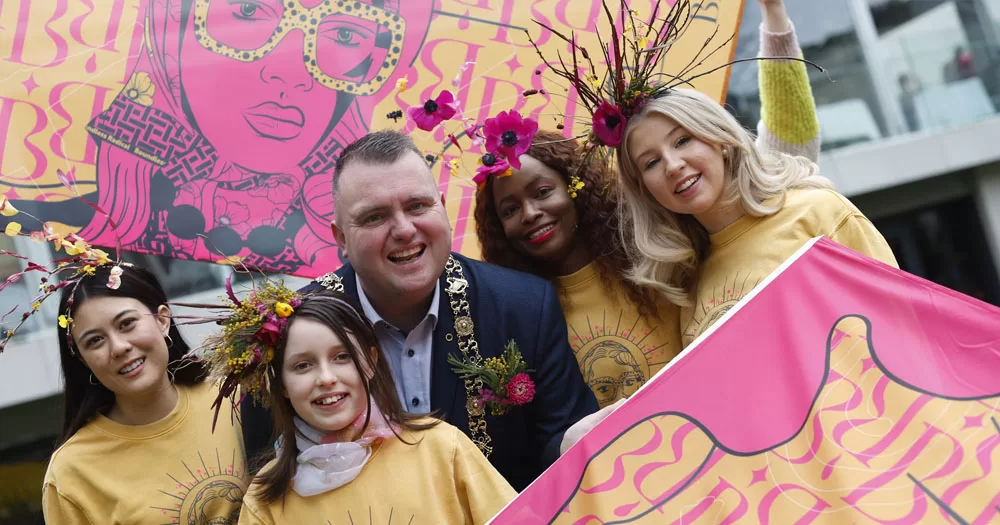 The image shows the Lord Mayor of Dublin surrounding by four women. Behind and in front of them are banners for Brigit 2024.