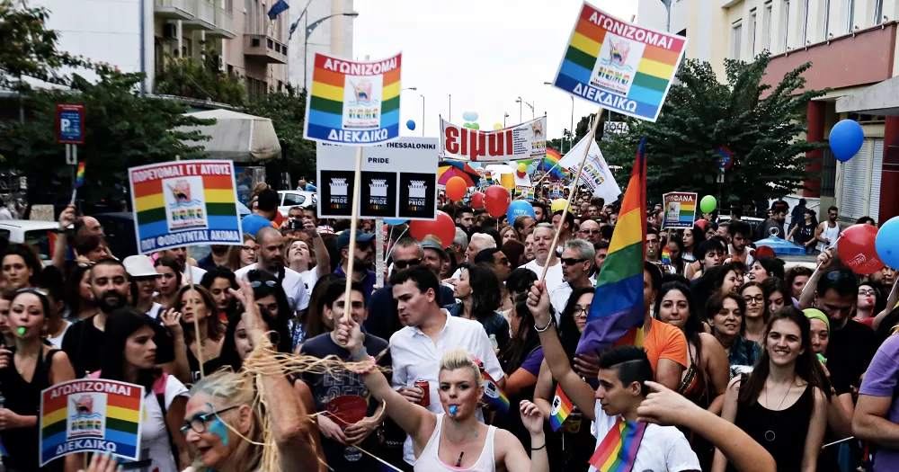 Pride Parade in Greece, where same-sex marriage was recently legalised, with protesters carrying rainbow banners and flags.