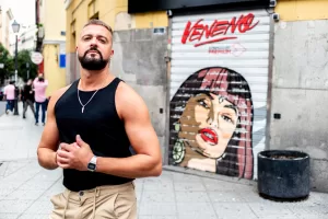 Pablo SM standing in front of a mural of Veneno in Madrid for Elska photoshoot. 