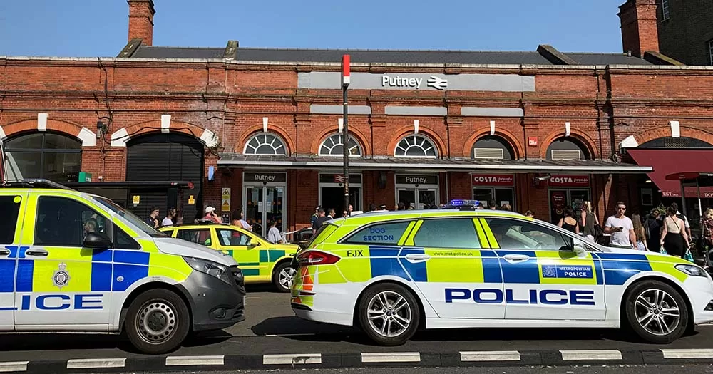 Photo of police vehicles in London. The article is about recent arrests in London following the stabbing of a trans teenager.