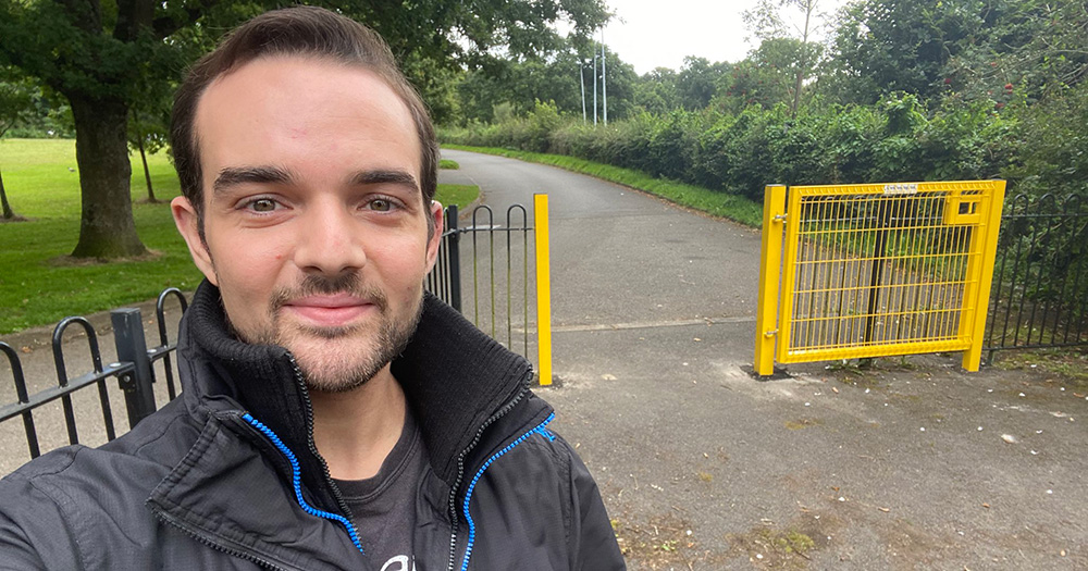 A selfie of Micky Murray, the new Lord Mayor of Belfast. He stands on the left hand side of the image smiling, with a park visible in the background.