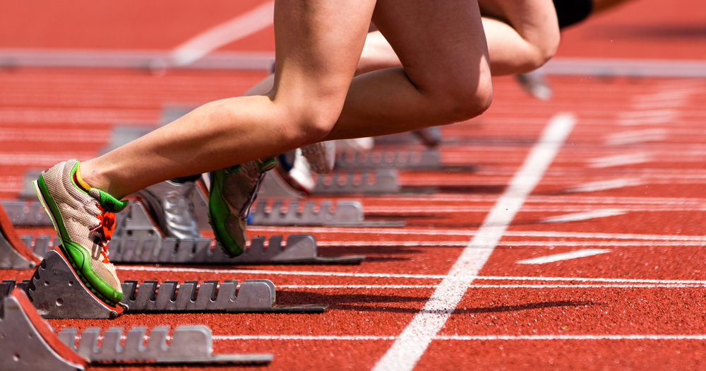 This article is about an open letter written to Sport Ireland. The image shows legs of athletes on a track right before the competition starts.