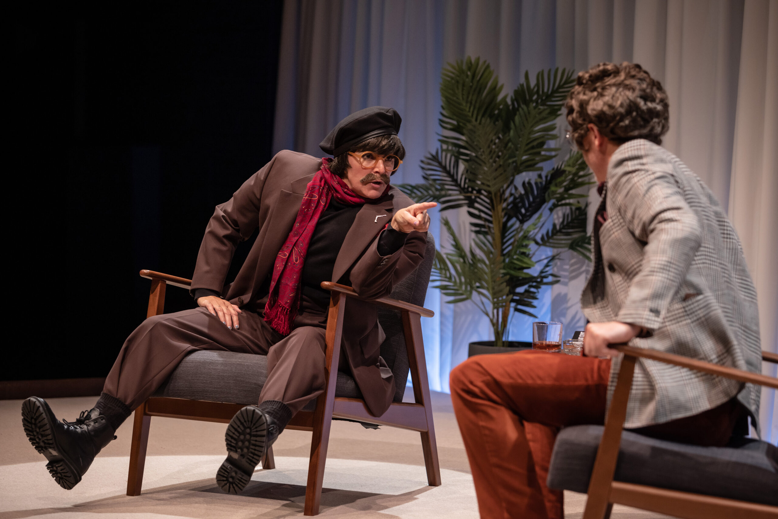 Two Brokentalkers performers sitting in chairs on stage