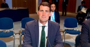 Photo of Jack Chambers wearing a suit and sitting in front of a microphone, Leo Varadkar predicted he may be the "next gay taoiseach"