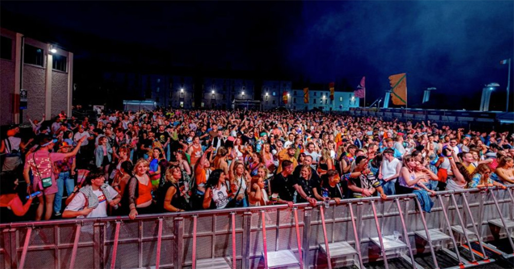 A view from the Mother Pride Block Party main stage of a large crowd of people at night time.