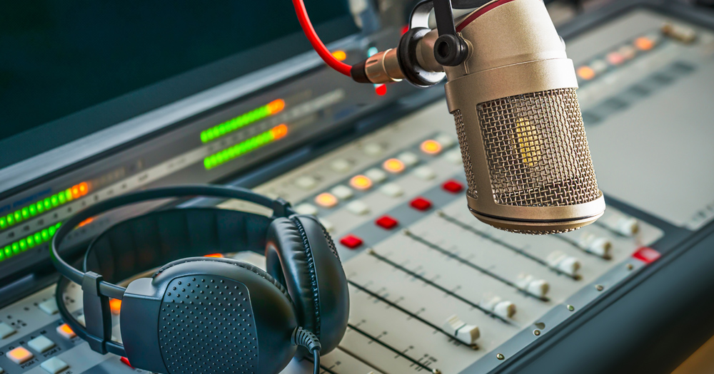 The article is about a new radio show, Out in Cork. The image shows headphones and microphone at a recording studio.