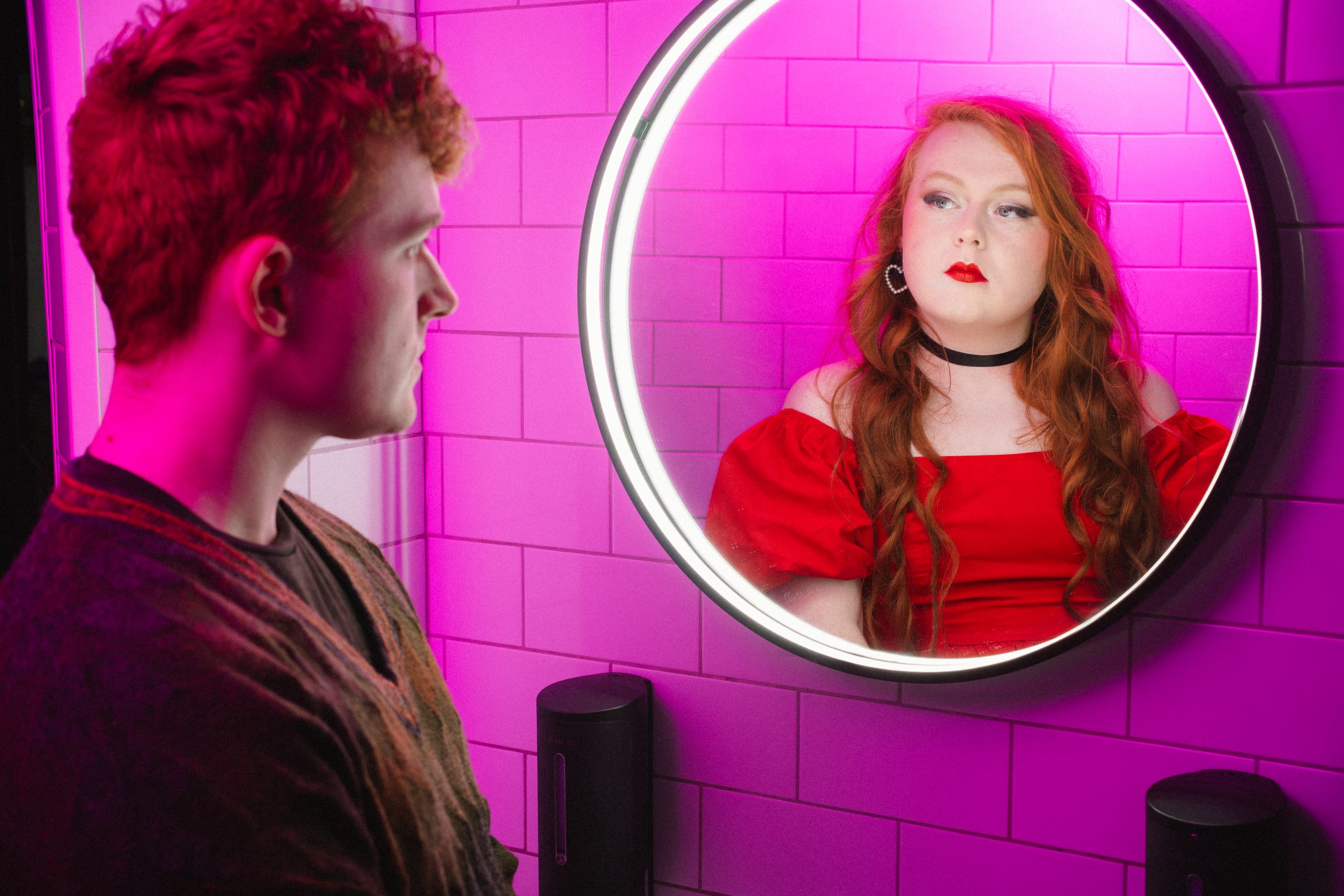 Image shows the character looking into the mirror and seeing Rose reflected back. 