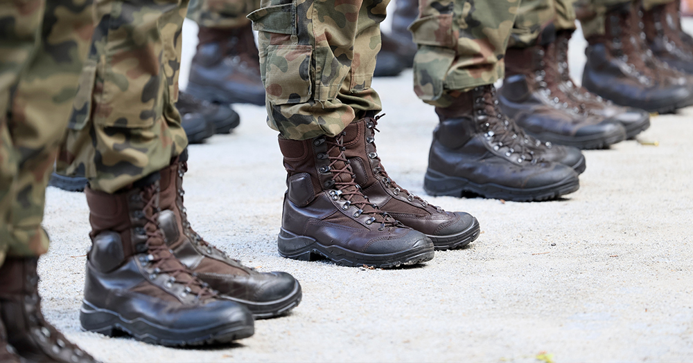 This article is about the soldier who assaulted Natasha O'Brien being discharged from the Defense Forces. in the photo, the legs of military personnel dressed in uniform.