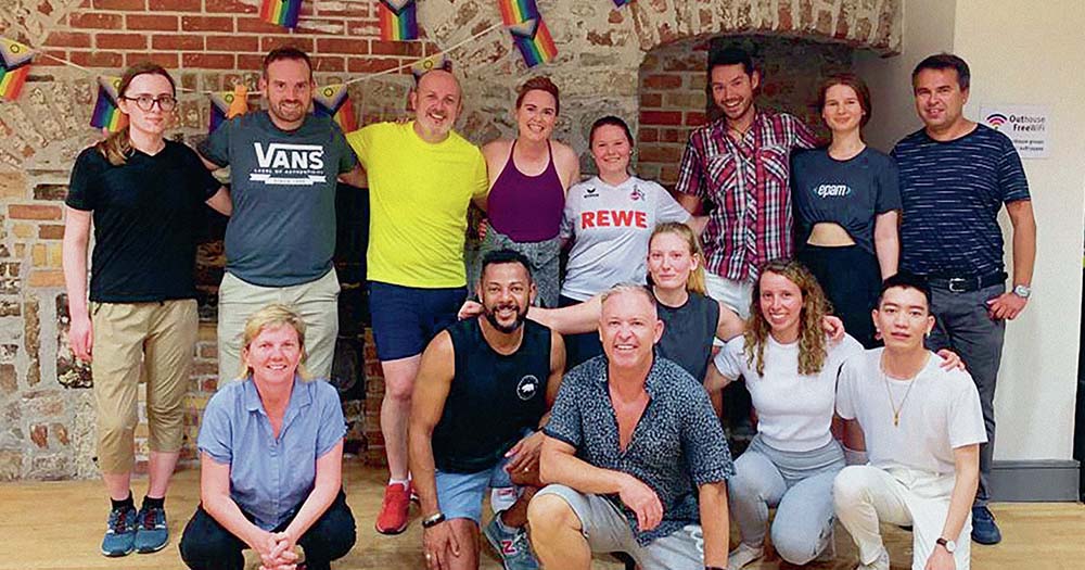 Group photo of members of Irish dance class with queer Irish dance teacher Wayne Webster of Webster Irish Dance Academy