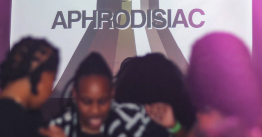 An image from Aphrodisiac's first club night in Dublin. The Aphrodisiac sign is visible in the background, with people dancing out of focus in the front.