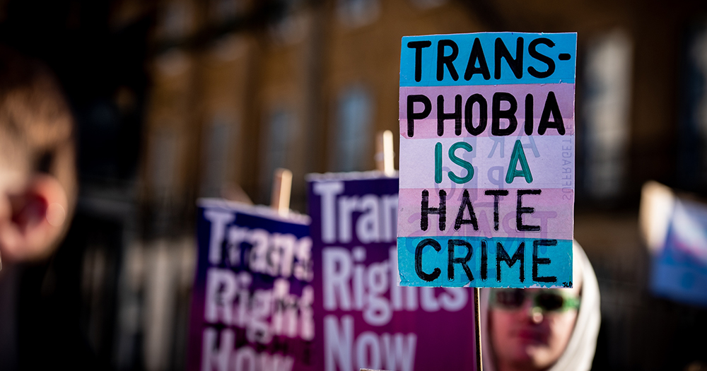 A sign reading "trans phobia is a hate crime".