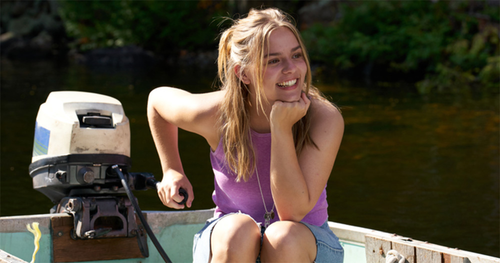 Image of Maisy Stella in My Old Ass. She sits on a boat, smiling.