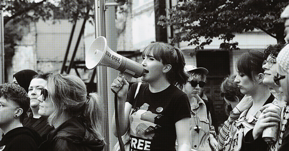 This article is about student activism. In the photo, young activism Jenny Maguire protesting with other people in black and white.