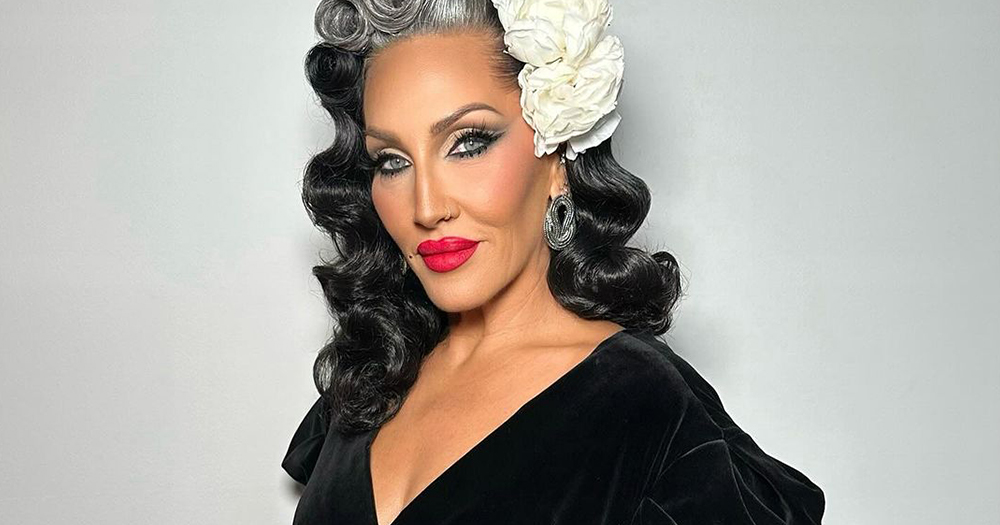 Portrait of Michelle Visage, who just joined a queer comedy series, wearing a black dress.