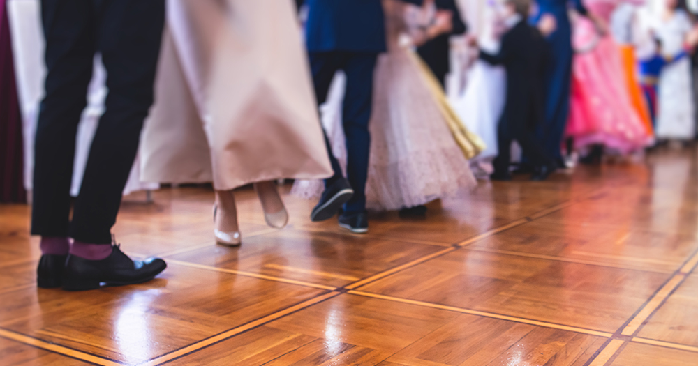 This article is about a prom night organised by Wexford Pride. In the photo, the legs of people at a ball.