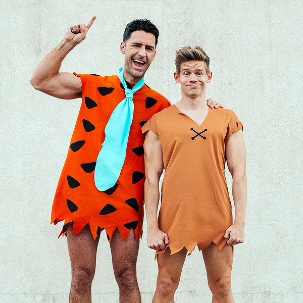 This picture shows two men in Fred Flintstone and Barney costumes.