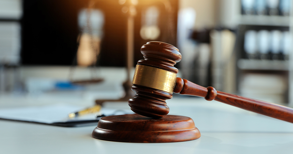 This article is about a Dublin man sentenced to jail for kicking a dog. In the photo, a gavel resting on a table.