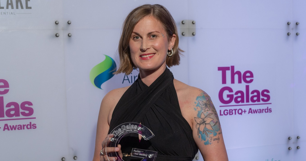 Ranae von Meding, an Irish activist for LGBTQ+ families, smiling at the camera with a GALAS award in her hands.