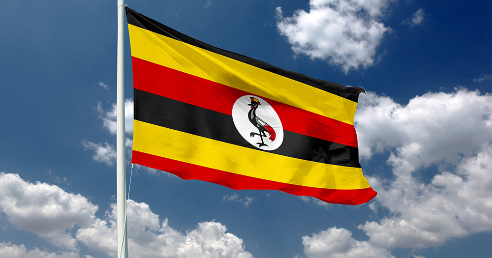 This article is about Uganda losing $1.6 billion because of the anti-LGBTQ+ law. In the photo, a Ugandan flag with the sky in the background.