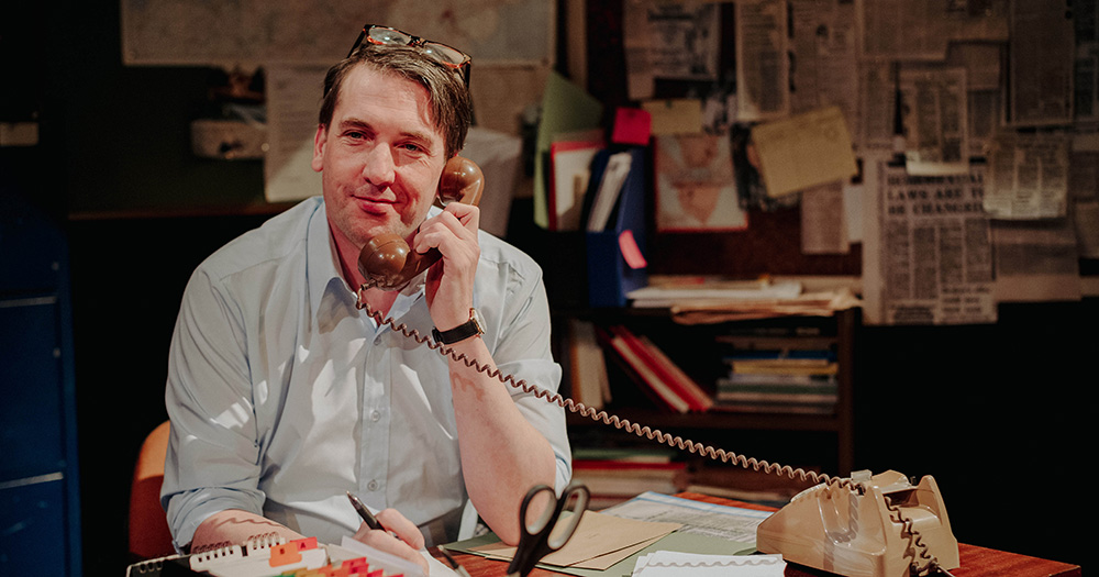 An image from the play Callings. It shows one of the actors on stage on a telephone.