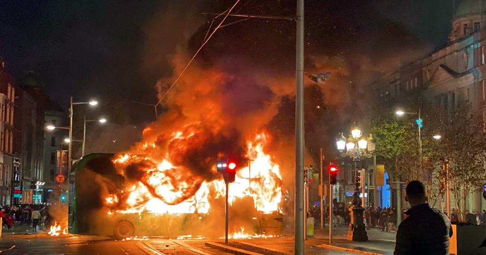 Photo taken during the Dublin riots, with gardaí releasing photos of 99 "person of interests" connected with the events. The photo shows a bus on fire in Dublin's city centre.