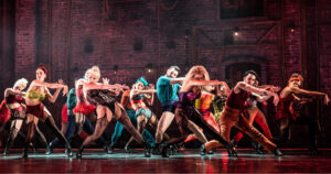 Performers of Moulin Rouge! The Musical, set to come to Dublin in 2025, dancing in a big group, dressed in lingerie.