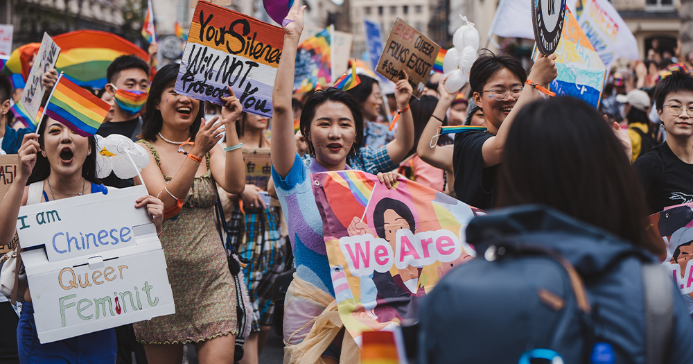 This article is about a trans woman winning compensation for conversion therapy. in the photo, people celebrating Pride.