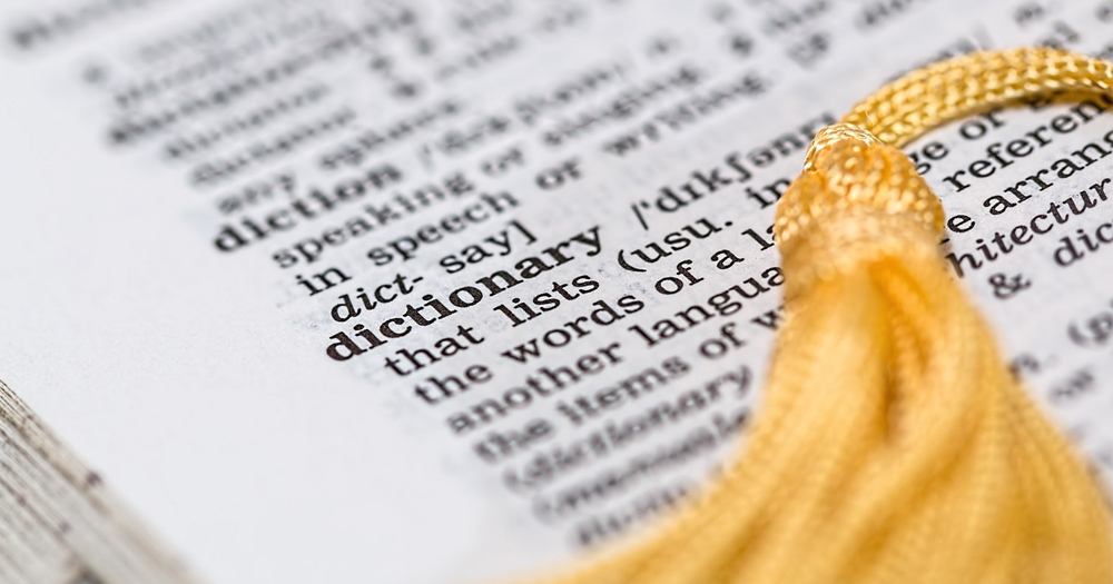 A close-up of a dictionary page with a bookmark placed on top, as an indicator of the implementation of neutral gender language