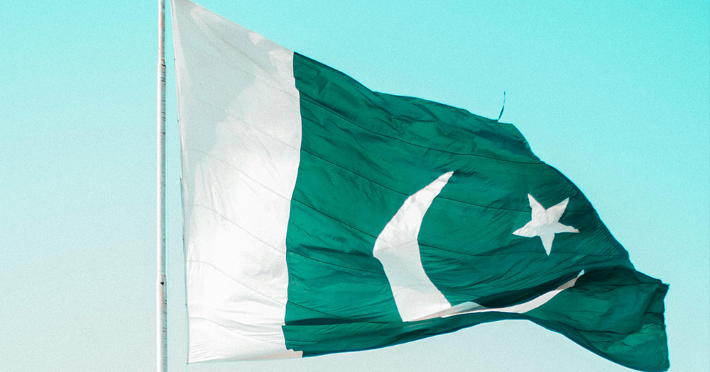 This is an article about a ride-sharing service in Pakistan serving only trans people and women to ensure their safety. Pictured is the flag of Pakistan.