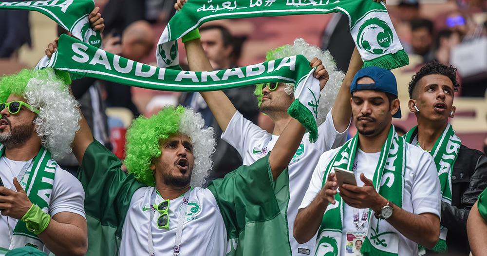 An image of Saudi Arabia football fans in the crowd at a World Cup match.