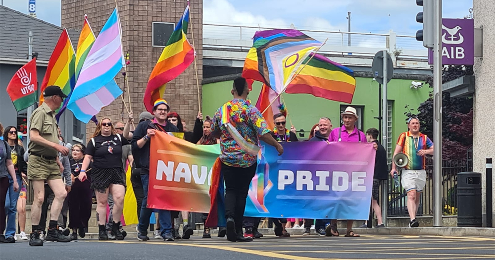 People marching waving Pride flags and a banner that reads Navan Pride, with the festival set to return in 2025.