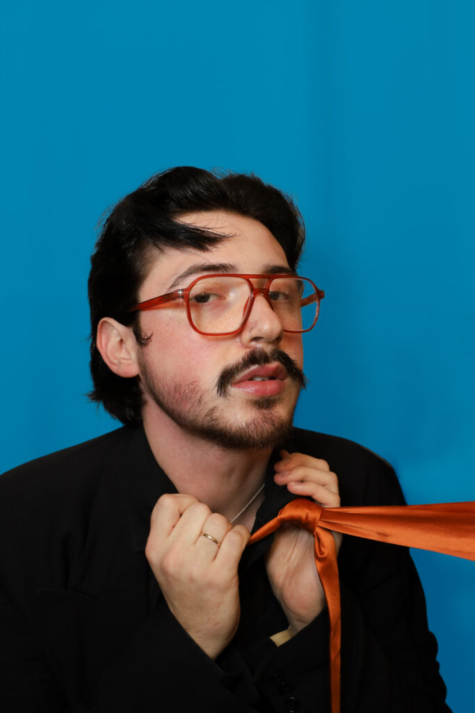 Oran O'Reilly in front of a blue background