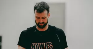 AJ Ogilvy wearing a black Hawks shirt