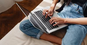 A person using a laptop this article covers an Irish lesbian recounts her experience on coming out during the rise of the conservative web