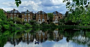 Hampstead Heath pond in London, with houses in the background.