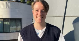 Photo of Mirjam Prell smiling at the camera while standing in a balcony.