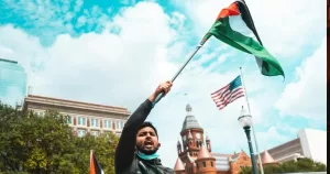 A man waves a Palestinian flag.