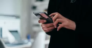 This article is about image-based sexual abuse. in the photo, a person holding a phone and typing.