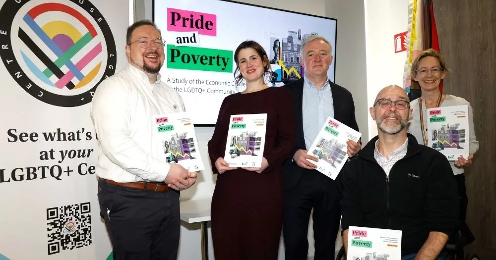 Photo taken at the launch of the Pride and Poverty report, on inequalities faced by the LGBTQ+ community in Ireland, with people who worked on the study posing for a picture with the reports in their hands.